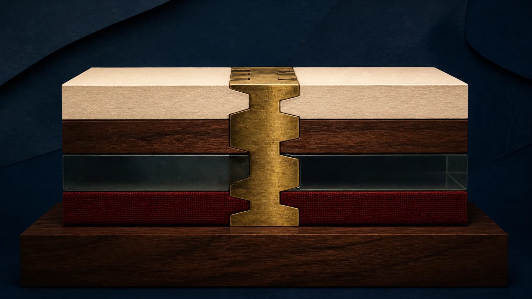 A precision aged-brass dovetail locks cream paper, walnut, smoky glass and oxblood fabric into one load-bearing beam.